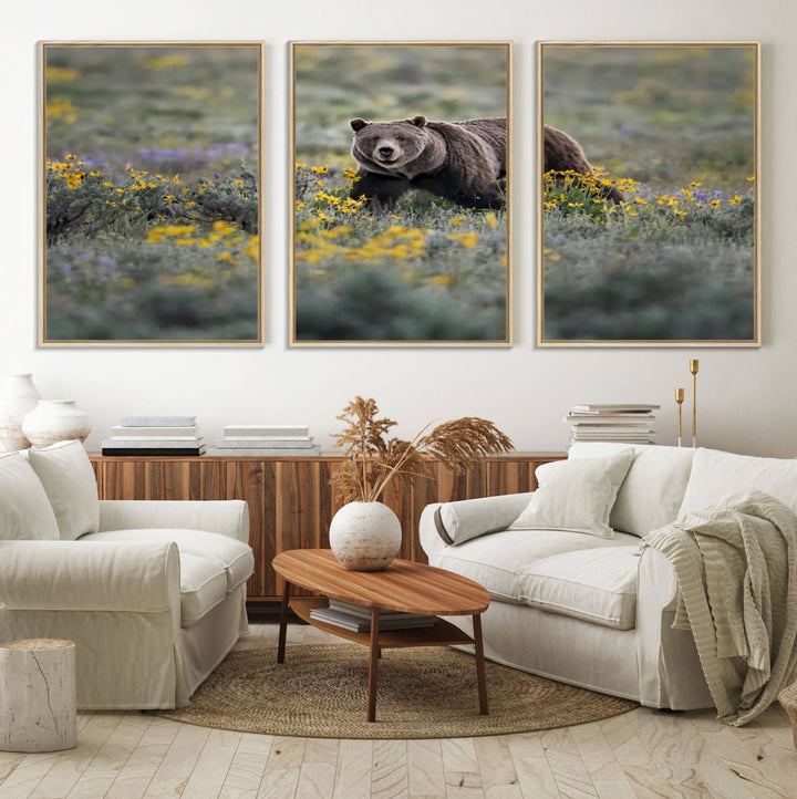 The "Grizzly 399 in Wild Flowers Wall Art Canvas Print" features a grizzly bear strolling through a field of yellow and purple flowers, beautifully showcased as a triptych. This handcrafted piece, proudly made in the USA, adds charm and sophistication to your space.