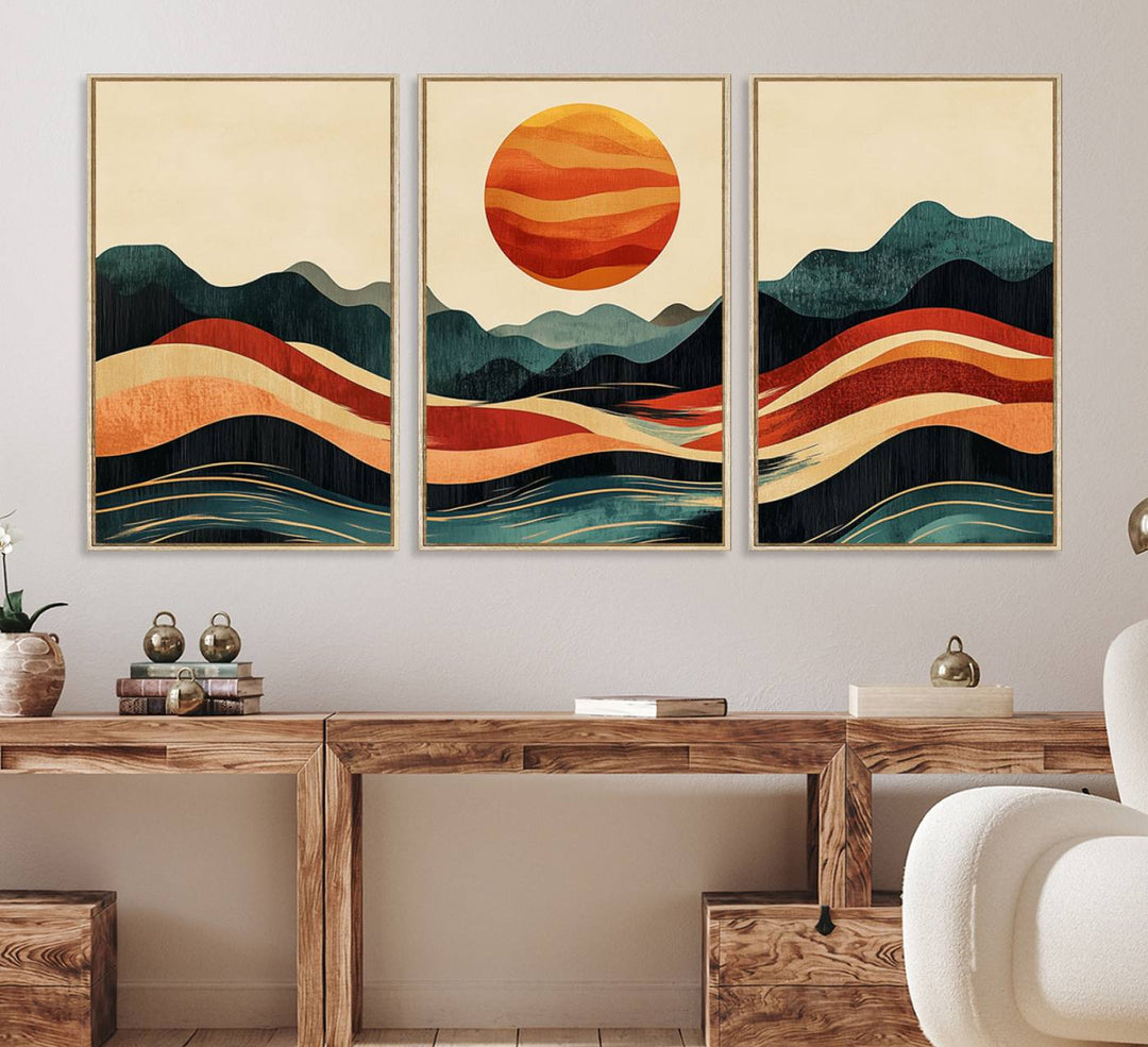 The Mountain Triptych wall art, featuring a design of the sun, mountains, and waves, is displayed prominently on the wall.