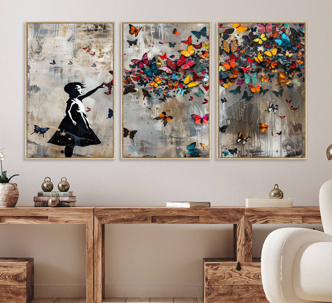 The Banksy Butterfly Girl 3-Piece Modern Graffiti Canvas Wall Art features a silhouette of a girl reaching for butterflies.