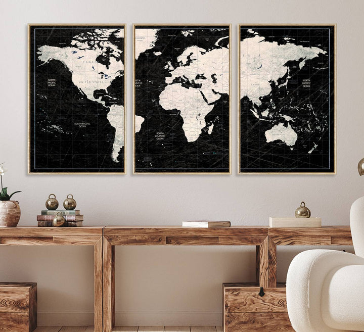 A bold global style framed black and white world map canvas print, presented in three panels, perfect for modern home or office decor.