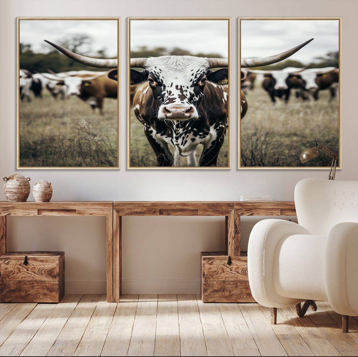 Canvas of a speckled Texas longhorn standing boldly in a field with a herd behind, perfect for rustic western or farmhouse wall decor.