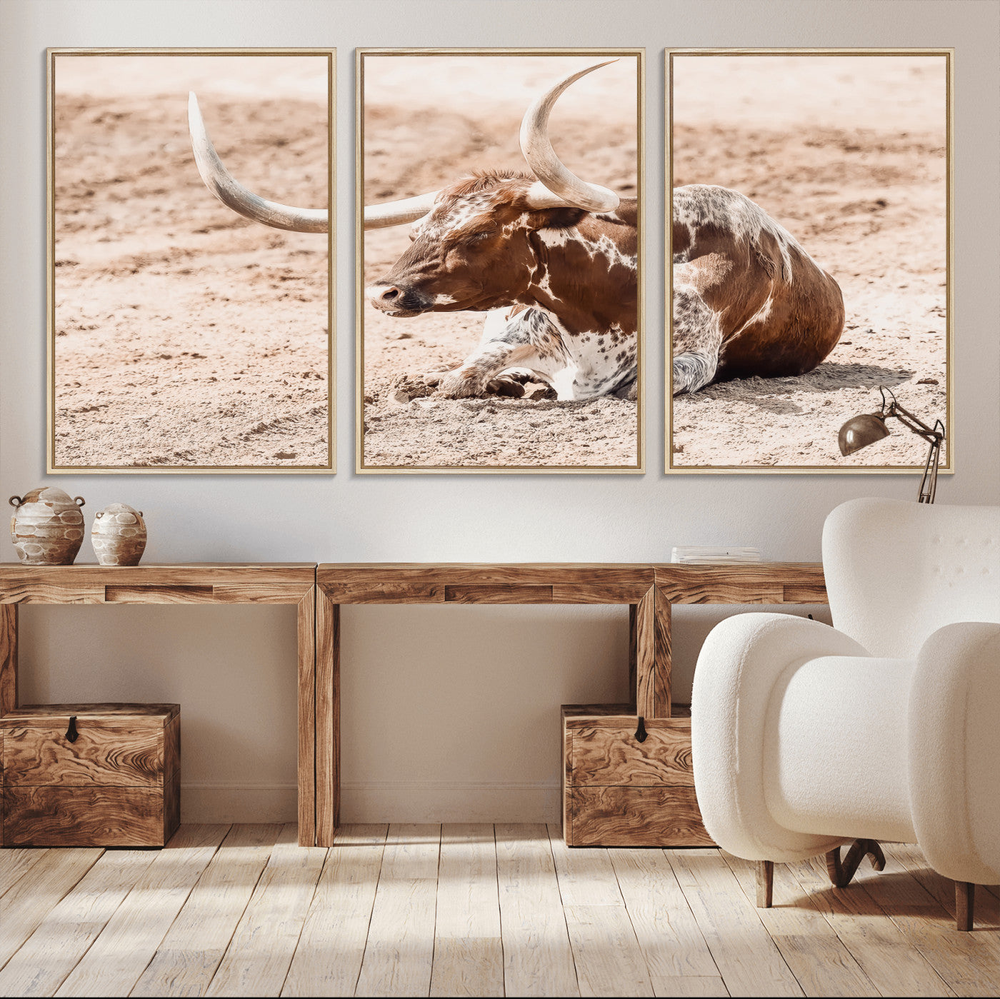 Texas Longhorn bull resting on dusty ground with warm tones, ideal for rustic western or farmhouse-themed wall decor.