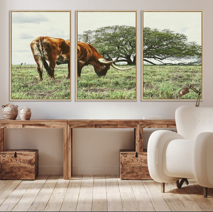 A Texas Longhorn grazing in a green pasture with a large tree in the background, evoking a rustic Western and farmhouse aesthetic.