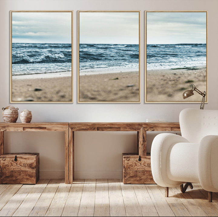 A moody ocean scene with gentle waves washing onto a sandy beach under a cloudy sky, creating a peaceful and coastal atmosphere.