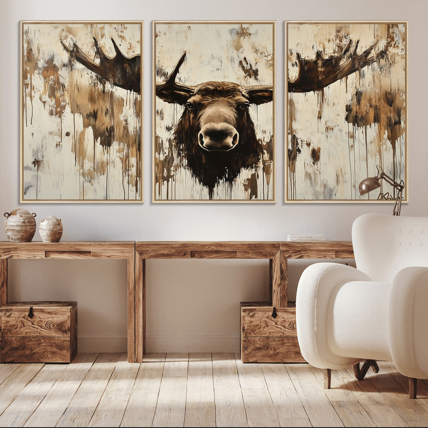 Expressive painting of a moose head with wide antlers in dark brown and beige tones, featuring paint drips and splatters on a light textured background, creating a striking rustic wall art canvas.