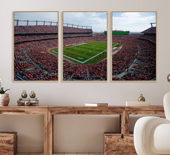 The Denver Broncos Football Print features a vibrant, fan-filled orange stadium overlooking the football field.