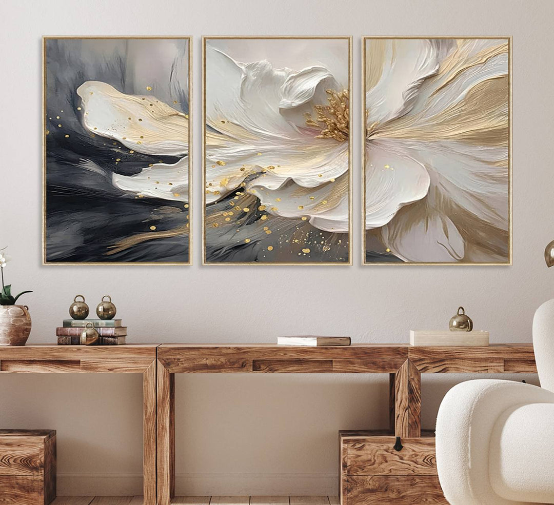 Elegant White and Gold Floral Triptych Canvas Art, a modern textured flower painting for home or office decor, features a blurred gray background.