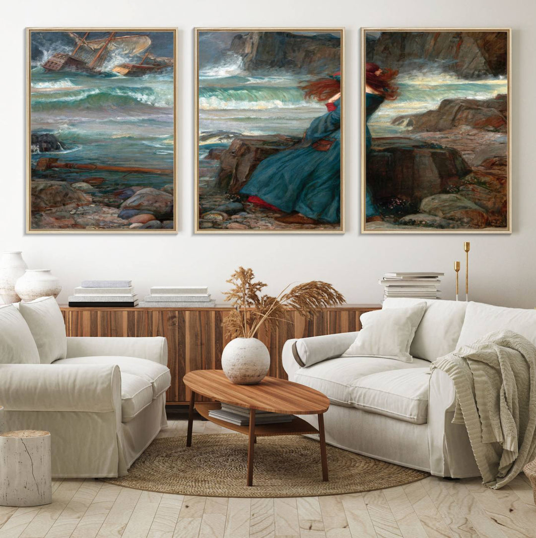 The Miranda by the Shore Wall Art Canvas Print depicts a woman in a blue dress standing by the sea, watching a shipwreck.