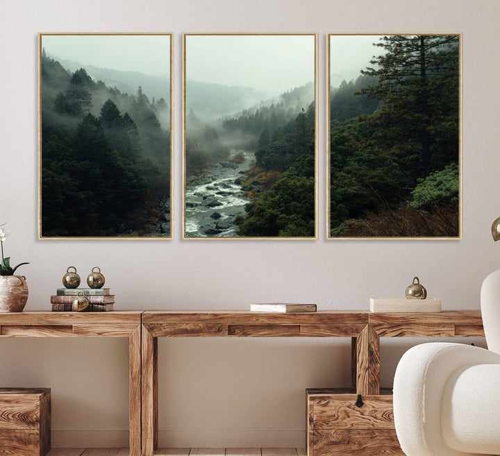 The Misty Forest Wall Art features a serene landscape with a misty river and evergreens, ideal for enhancing the ambiance of any living room or cabin.