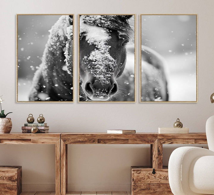 The Black and White Horse Winter Wall Art features a majestic horse with snow-covered hair set against a serene winter backdrop.