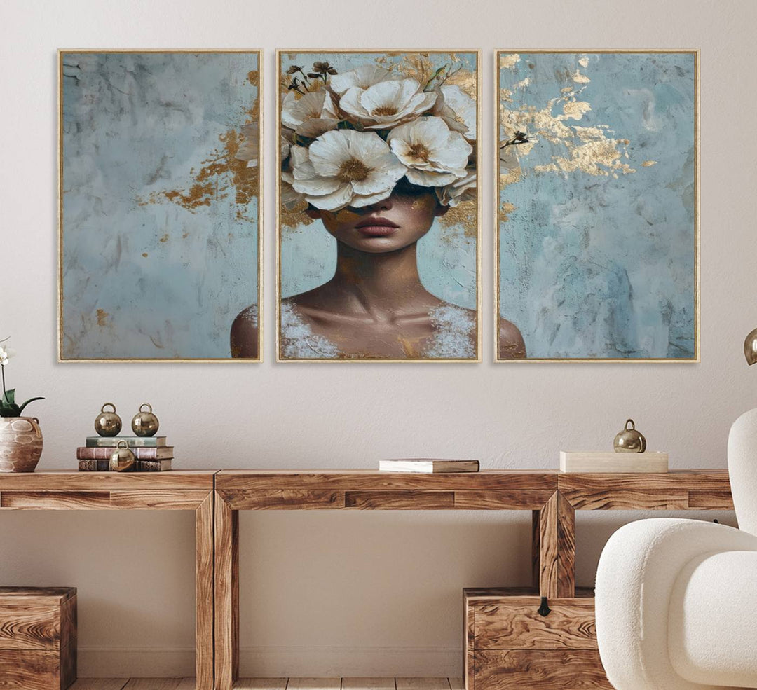 Golden Petal Wall Art: A womans face adorned with a gold floral design on a teal background, presented in a 3-panel modern glam canvas.