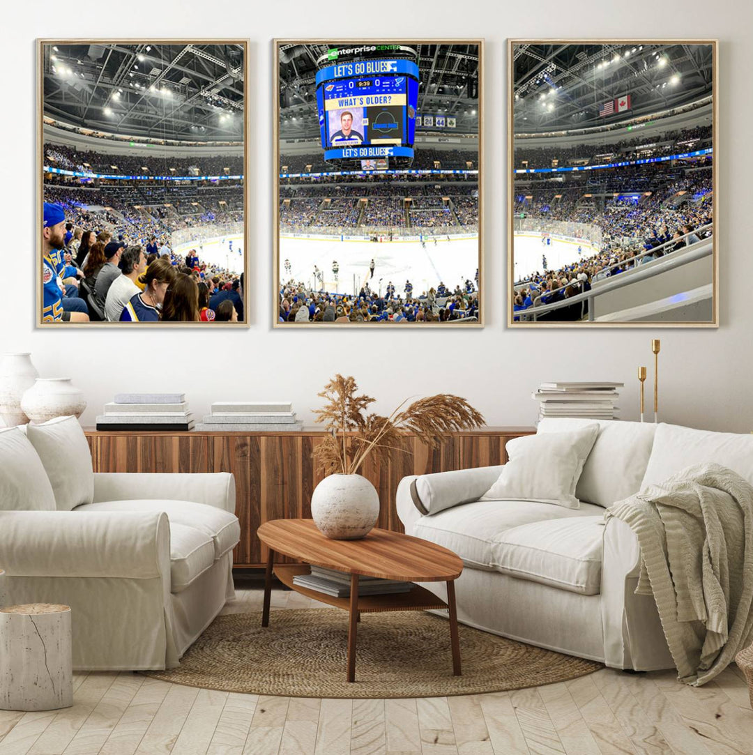 Wall art prints depicting the bustling scenes of the St. Louis Blues being cheered on by a full house at the Enterprise Center, beneath a large scoreboard.