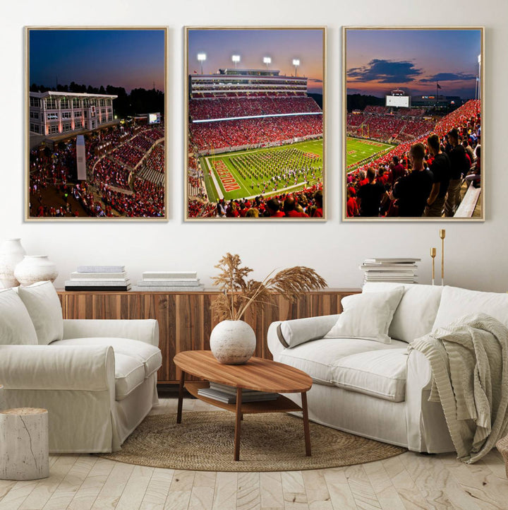 A print of a bustling Carter-Finley Stadium at dusk, featuring fans and a band, captures the essence of NC State Wolfpack football.