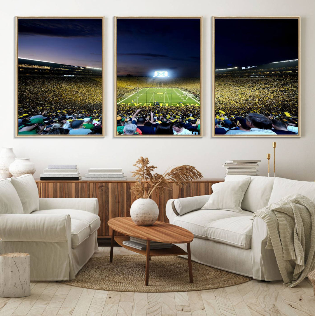 The wall art features a glowing M in this Michigan Wolverines Football Team Ann Arbor Stadium Canvas Print.