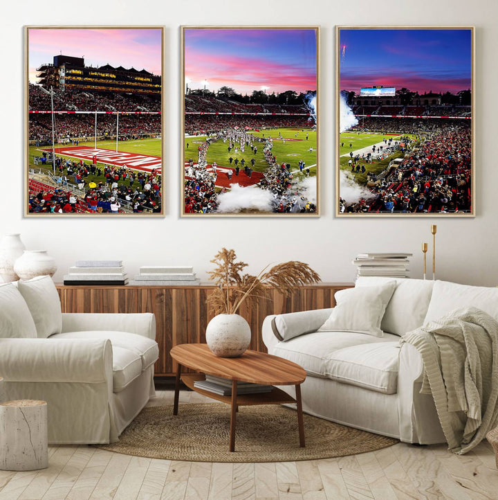 The wall art features a canvas print of the Stanford Cardinal football team, capturing players, fireworks, and smoke against the backdrop of a sunset at Stanford Stadium.