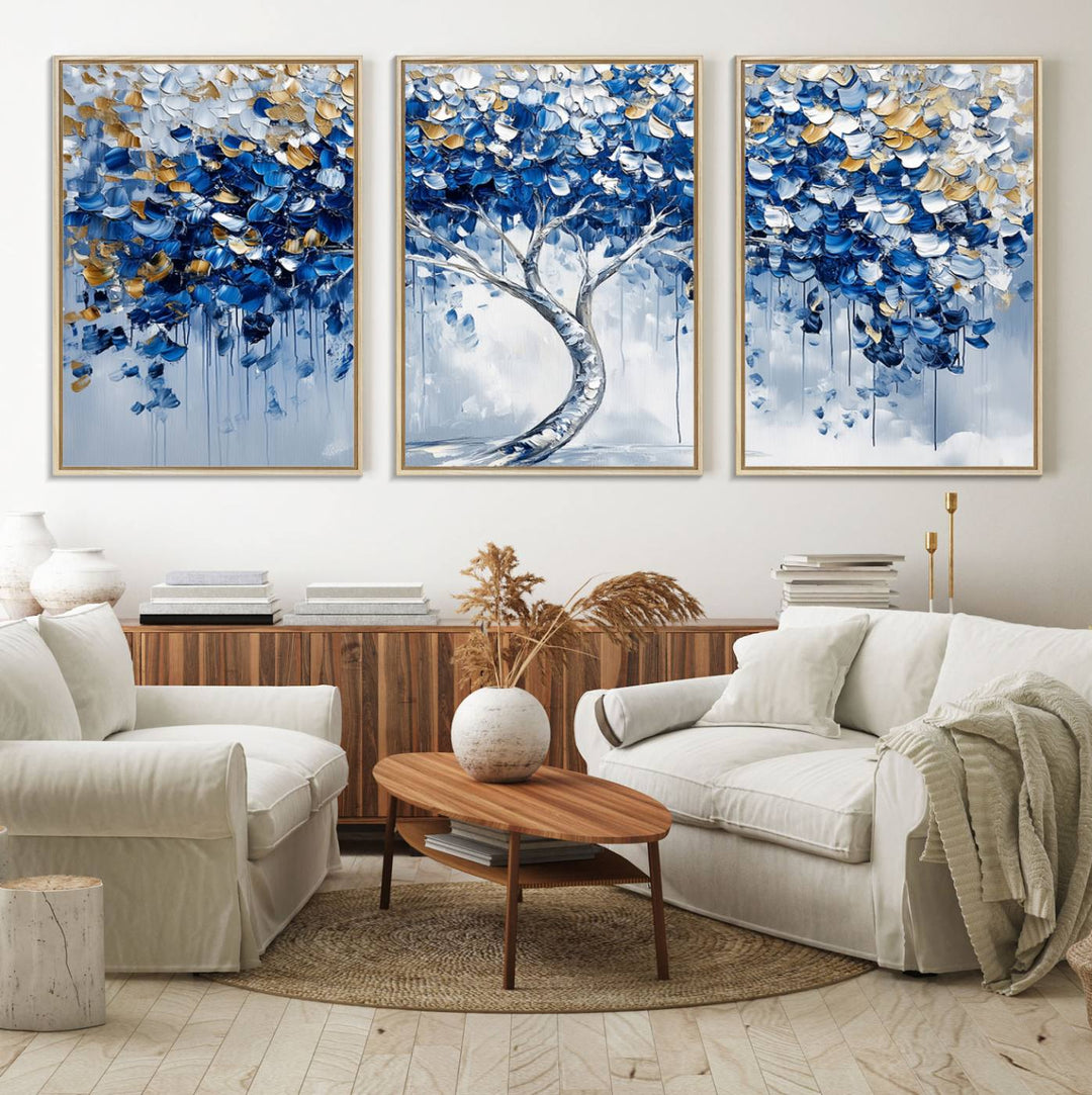 The Blue and Gold Abstract Tree Wall Art showcases a swirl trunk and features blue, silver, and gold leaves on a framed canvas print.