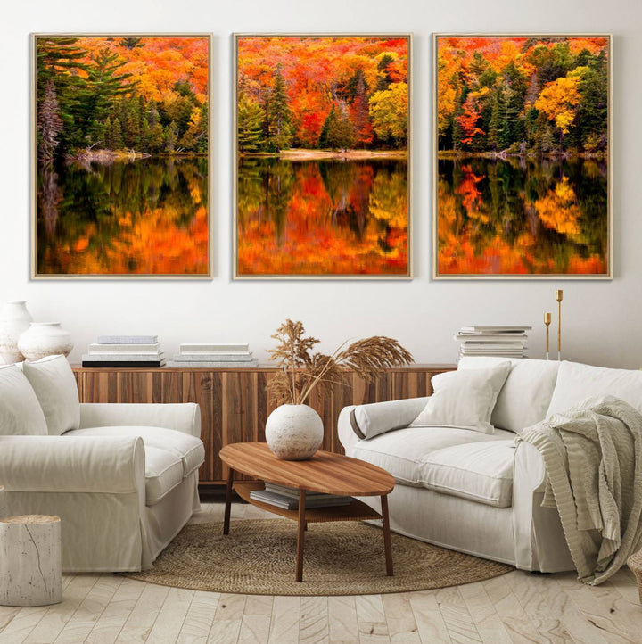 Autumn Forest Reflection Wall Art: a vibrant triptych canvas featuring fall foliage with red, orange, and yellow leaves over a calm lake.