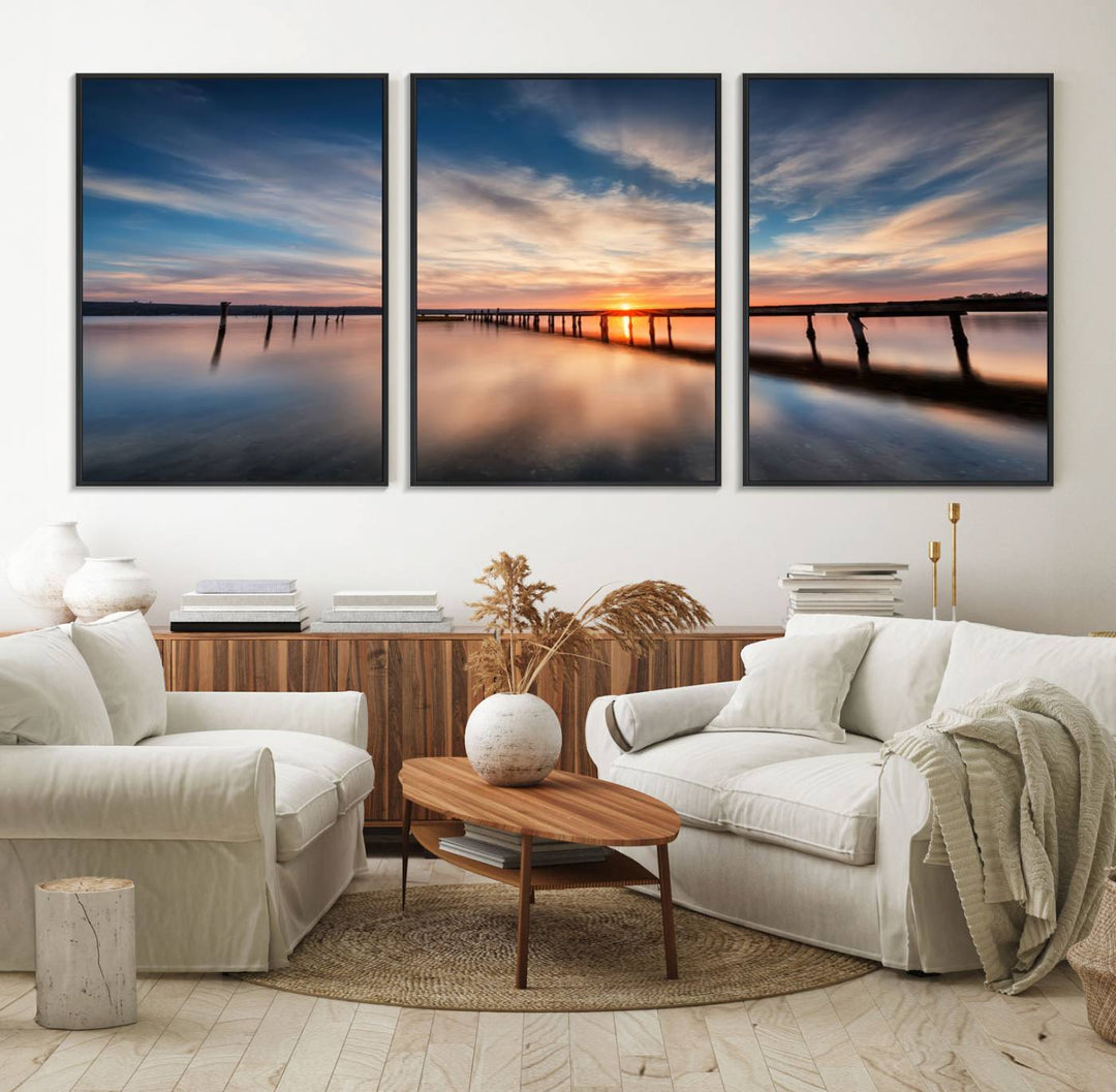 The Sunset Pier Canvas features a serene coastal landscape with vibrant hues under cloudy skies, ideal for modern decor.