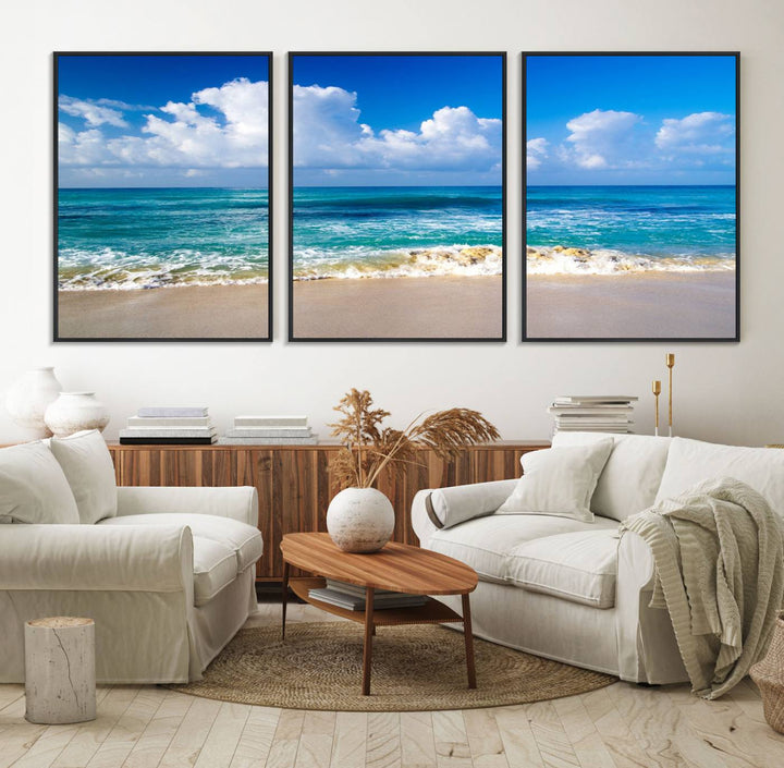 The Tropical Beach 3-Panel Canvas Wall Art features ocean waves gently lapping on a beach under blue skies, making it an ideal choice for coastal decor.