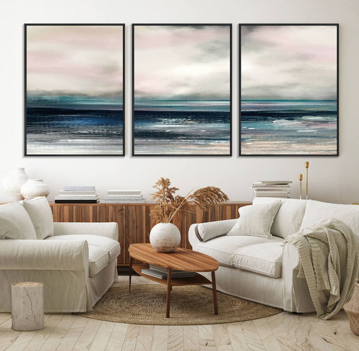 A contemporary abstract wall art canvas print in pastel pink, teal, and gray tones hangs on the wall.