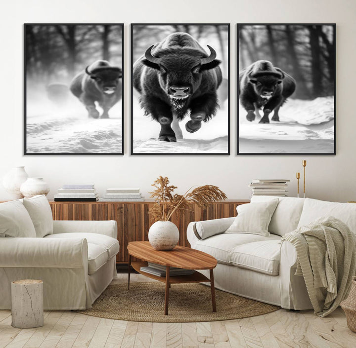 The Buffalo Wall Art Canvas Print of bison running through snow adorns the wall.