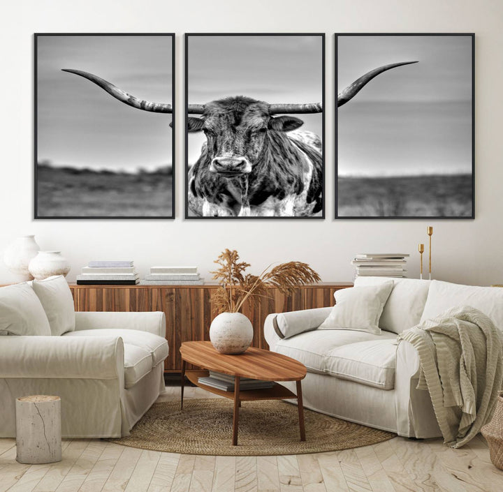 The Texas Longhorn Cow wall art, divided into three panels, is of gallery quality and displayed on a dark wall.