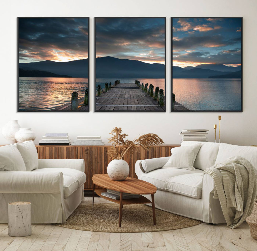 The Mountain Lake Wood Pier Canvas Wall Art depicts a serene lake and mountains, enhancing the beauty of any space.