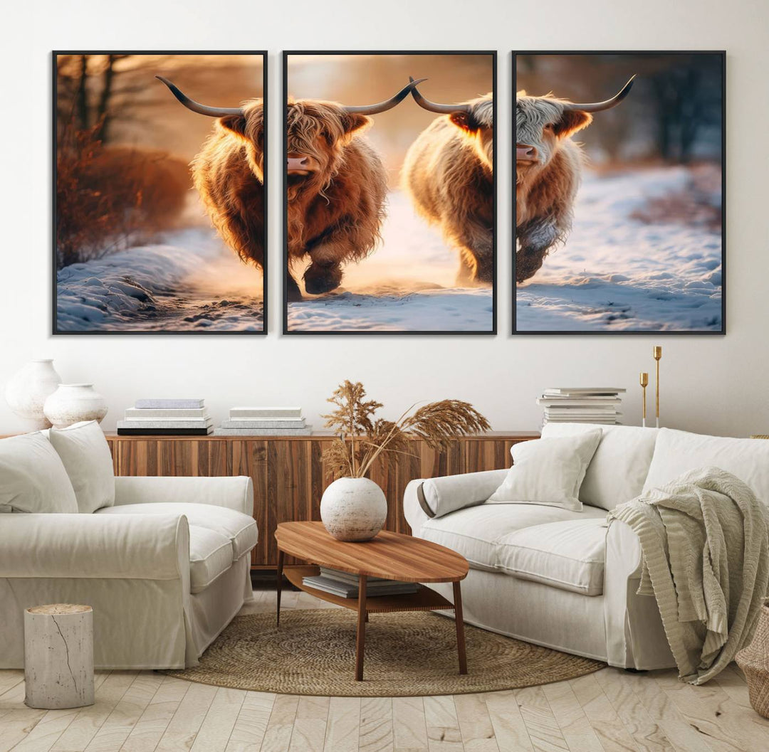 The wall art is a Scottish Highland Cow Horn canvas print featuring cows on a snowy path bathed in warm sunlight, serving as a rustic decor piece.