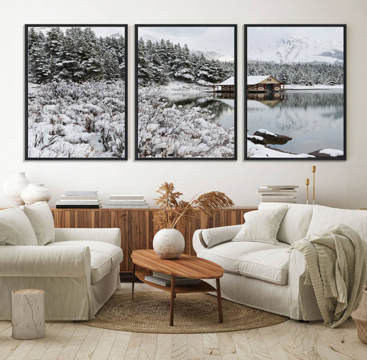 Experience the beauty of winter with the "Cabin by the Lake Canvas Wall Art," showcasing a serene snowy landscape. This rustic nature decor features a cozy cabin nestled amid snow-laden trees, set against a breathtaking mountain view, perfect for enhancing your living room.