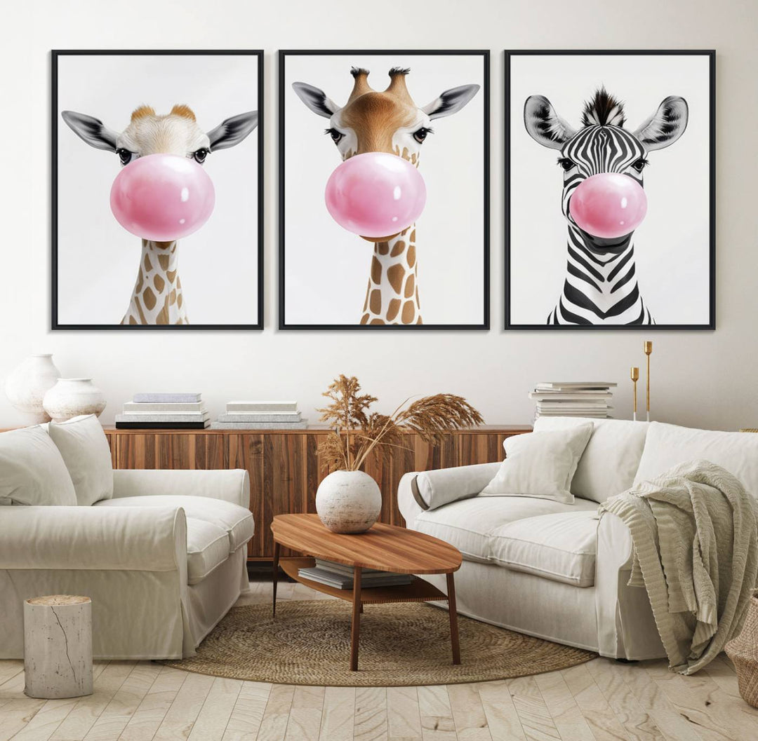 The Bubblegum Animals Canvas Wall Art, featuring a playful trio of giraffe and zebra portraits blowing pink bubblegum, brings charm and whimsy to your space. Ideal for nursery wall art or any fun area, this delightful decor piece is ready to hang and perfect for creating a playful atmosphere.