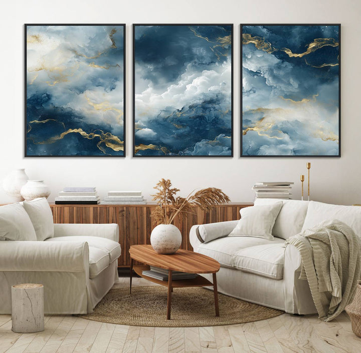 The "Large Abstract Print - Luxe Blue and Gold Abstract Canvas Wall Art" features a bold cloudscape design with swirling white patterns, ideal for modern home decor in living rooms or offices.