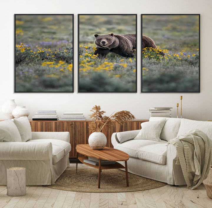 The "Grizzly 399 in Wild Flowers Wall Art Canvas Print" features a grizzly bear strolling through a field of yellow and purple flowers, beautifully showcased as a triptych. This handcrafted piece, proudly made in the USA, adds charm and sophistication to your space.