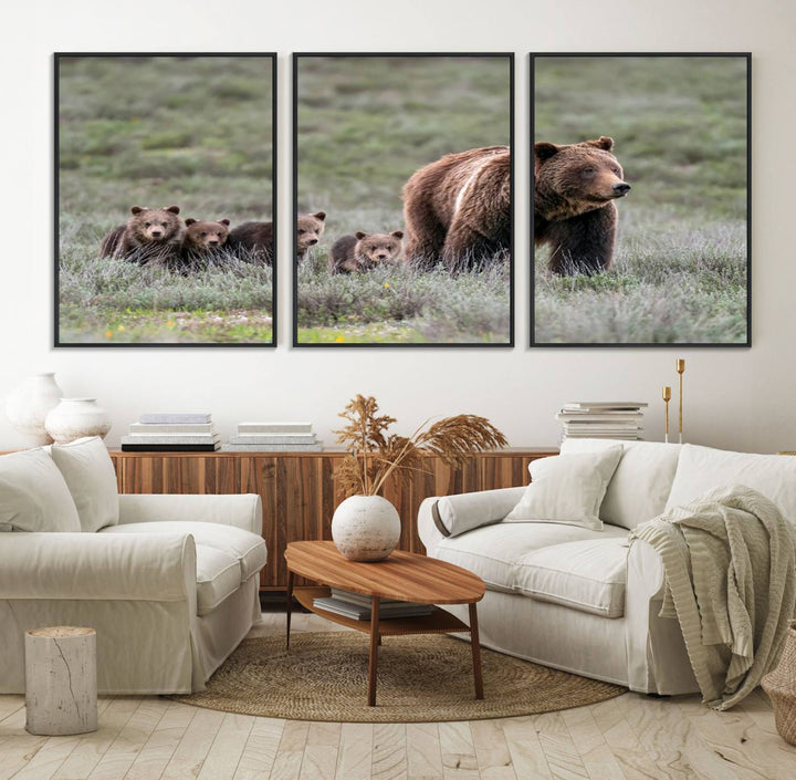 The large canvas print titled "Queen of the Tetons, 399 Grizzly Bear Cubs" showcases majestic wildlife photography of a bear and her cubs walking through the grass. This stunning canvas wall art, handmade in the USA, adds a charming touch to any room with its rustic decor appeal.