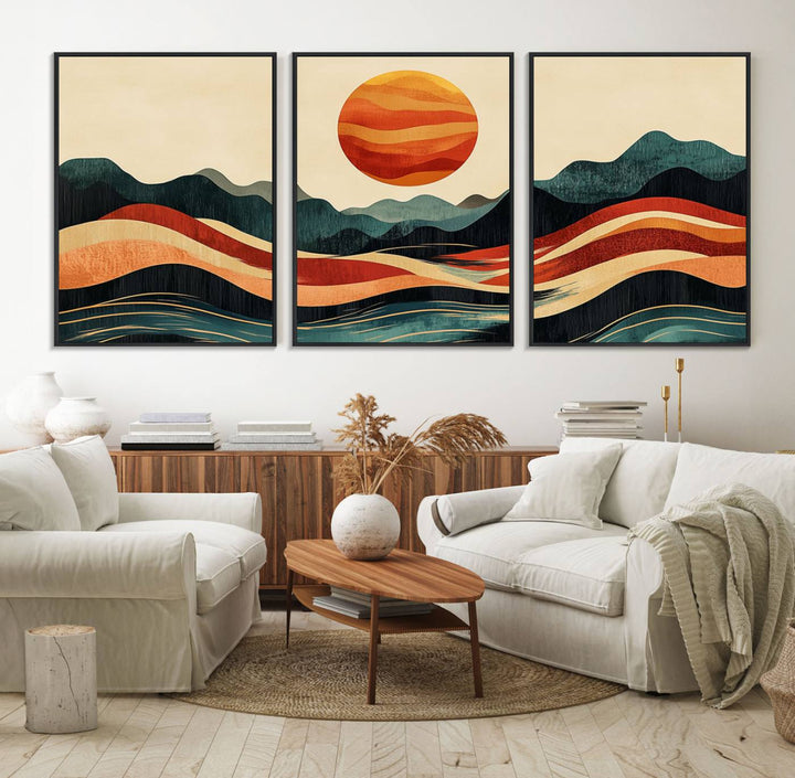 The Mountain Triptych wall art, featuring a design of the sun, mountains, and waves, is displayed prominently on the wall.