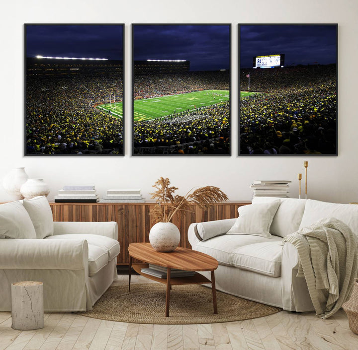 A painting of the packed Michigan Wolverines football stadium at night.