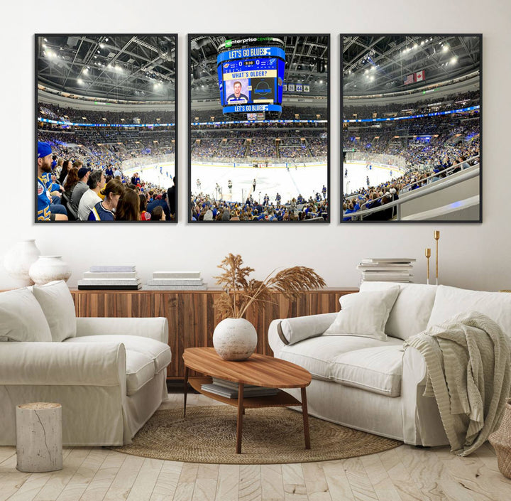 Wall art prints depicting the bustling scenes of the St. Louis Blues being cheered on by a full house at the Enterprise Center, beneath a large scoreboard.