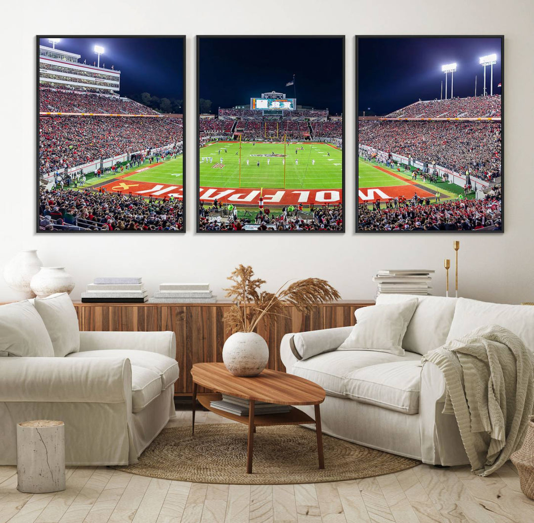 A NC State Wolfpack Football Team print of Carter-Finley Stadium at night features WOLFPACK illuminated brightly in the end zone grass.