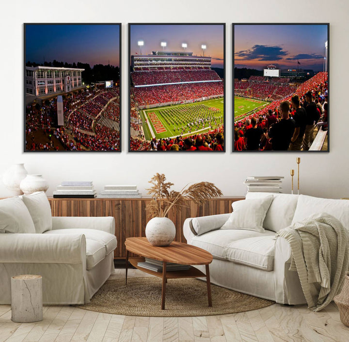 A print of a bustling Carter-Finley Stadium at dusk, featuring fans and a band, captures the essence of NC State Wolfpack football.