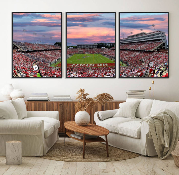 The wall art captures an NC State Wolfpack game under a vibrant sunset on triple canvas.