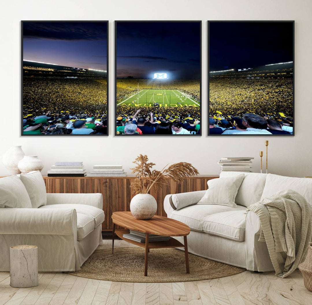 The wall art features a glowing M in this Michigan Wolverines Football Team Ann Arbor Stadium Canvas Print.