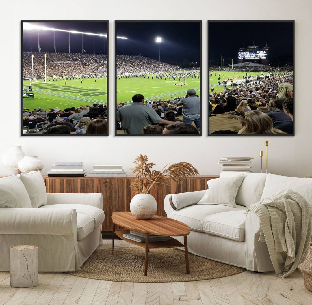 A painting depicting the Purdue Boilermakers football game at Ross-Ade Stadium is illuminated under gallery-quality lights.