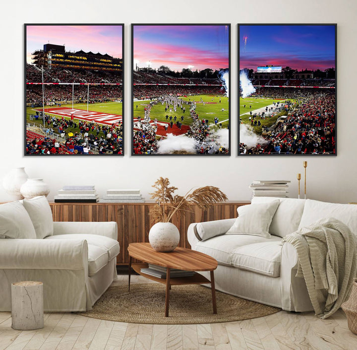 The wall art features a canvas print of the Stanford Cardinal football team, capturing players, fireworks, and smoke against the backdrop of a sunset at Stanford Stadium.