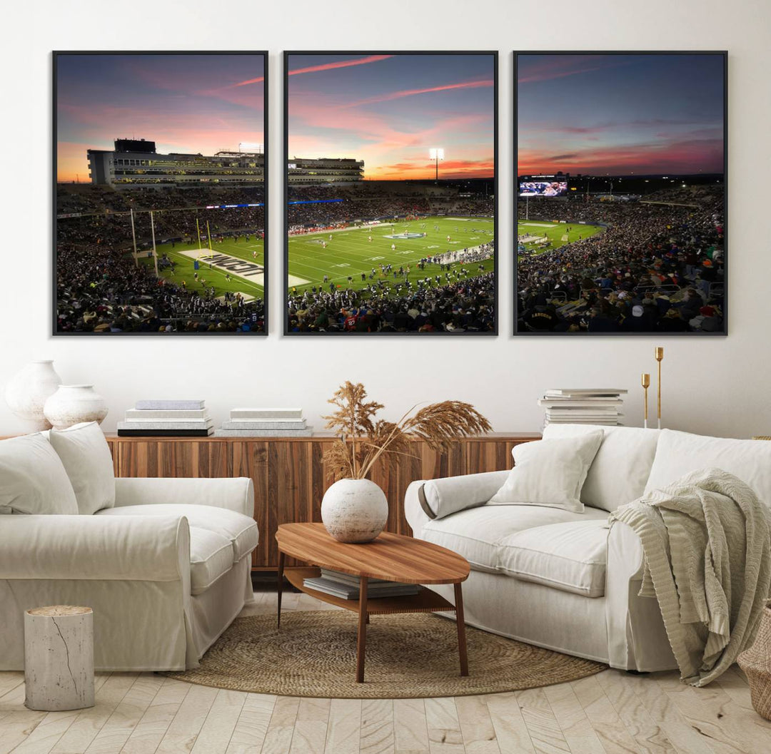 This wall art canvas print captures UCONN Huskies fans energizing a sunset scene at East Hartfords Pratt & Whitney Stadium.