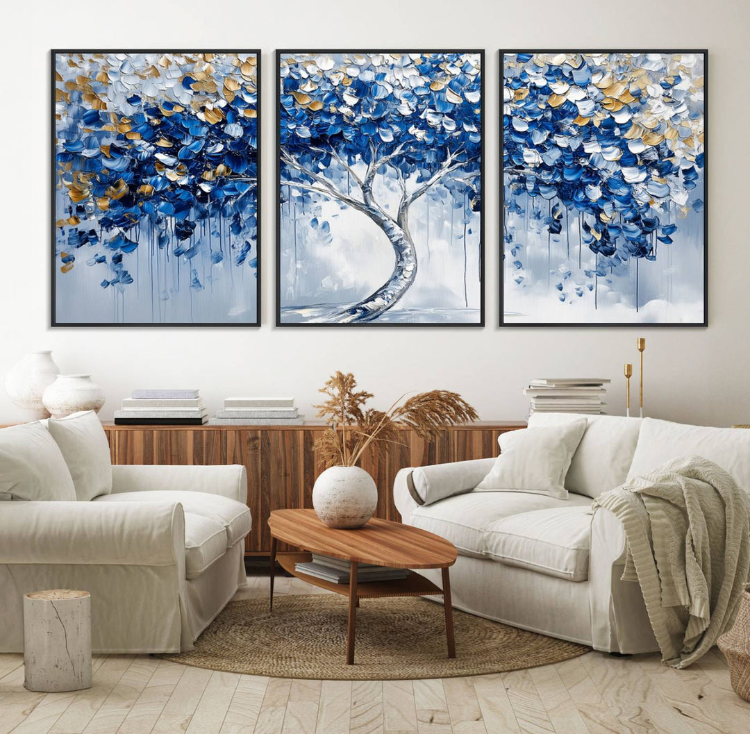 The Blue and Gold Abstract Tree Wall Art showcases a swirl trunk and features blue, silver, and gold leaves on a framed canvas print.