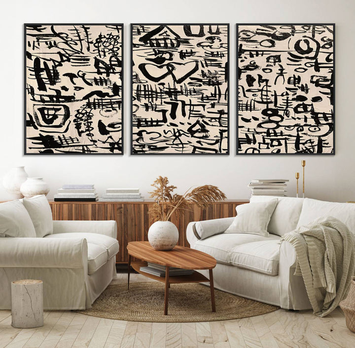 The Abstract Love and Chaos canvas is a museum-quality print featuring black symbols on a beige background, adorned with a heart and scribble design. It is framed to enhance its artistic appeal.