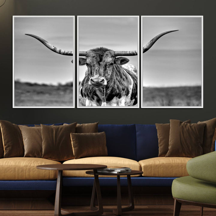 The Texas Longhorn Cow wall art, divided into three panels, is of gallery quality and displayed on a dark wall.