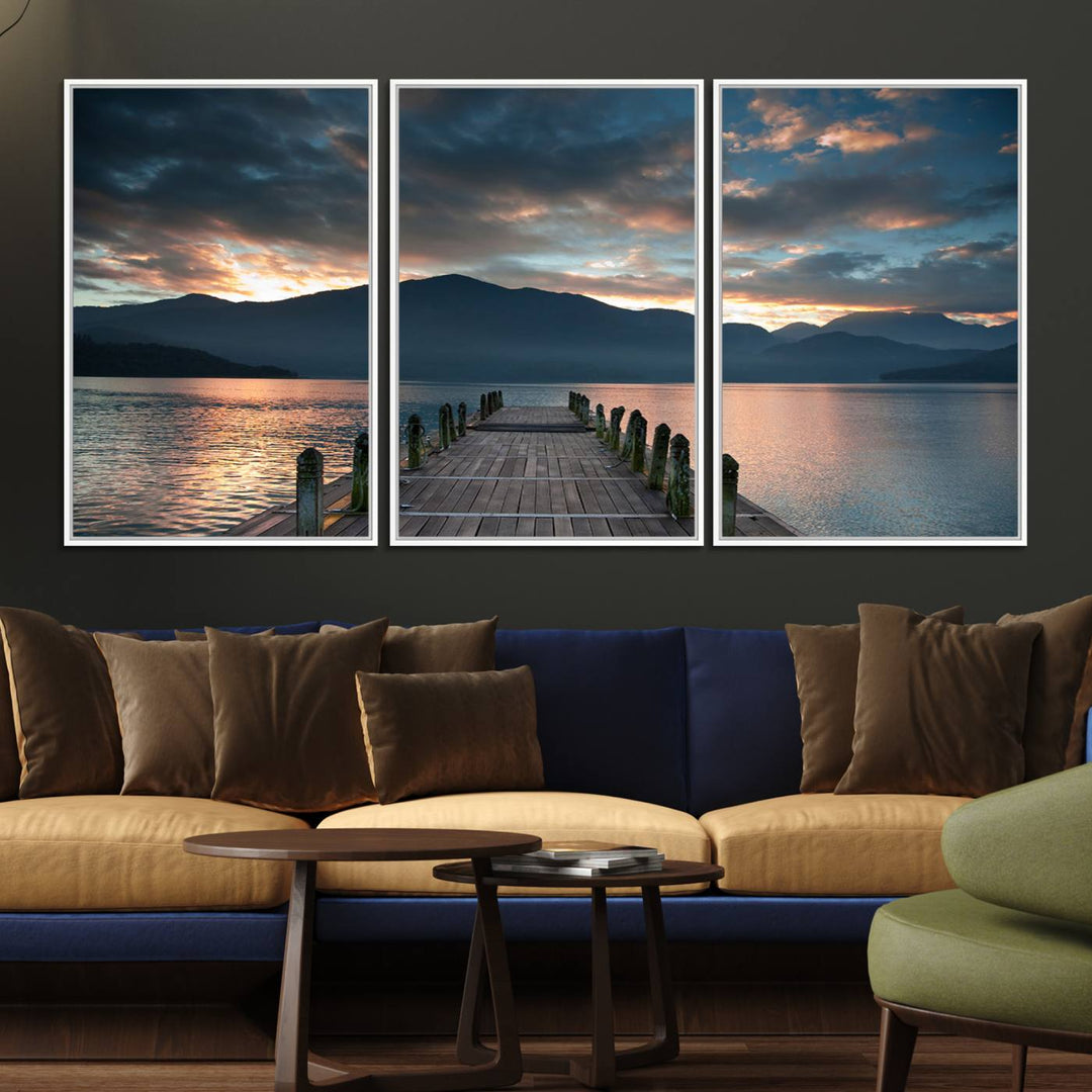 The Mountain Lake Wood Pier Canvas Wall Art depicts a serene lake and mountains, enhancing the beauty of any space.