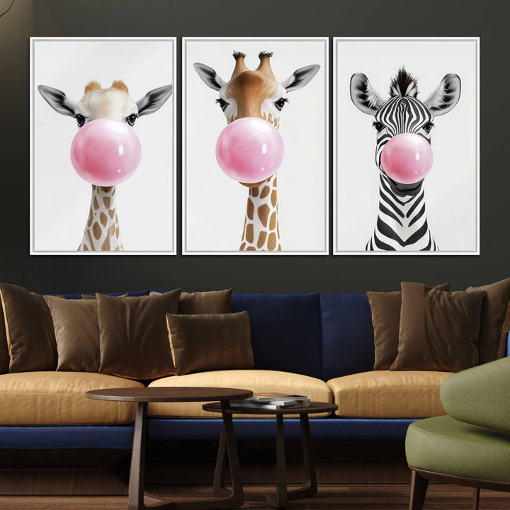 The Bubblegum Animals Canvas Wall Art, featuring a playful trio of giraffe and zebra portraits blowing pink bubblegum, brings charm and whimsy to your space. Ideal for nursery wall art or any fun area, this delightful decor piece is ready to hang and perfect for creating a playful atmosphere.