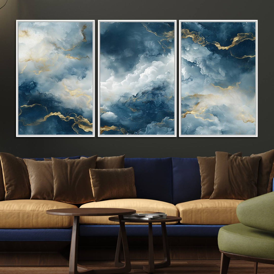 The "Large Abstract Print - Luxe Blue and Gold Abstract Canvas Wall Art" features a bold cloudscape design with swirling white patterns, ideal for modern home decor in living rooms or offices.