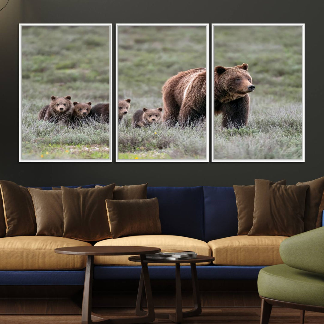 The large canvas print titled "Queen of the Tetons, 399 Grizzly Bear Cubs" showcases majestic wildlife photography of a bear and her cubs walking through the grass. This stunning canvas wall art, handmade in the USA, adds a charming touch to any room with its rustic decor appeal.